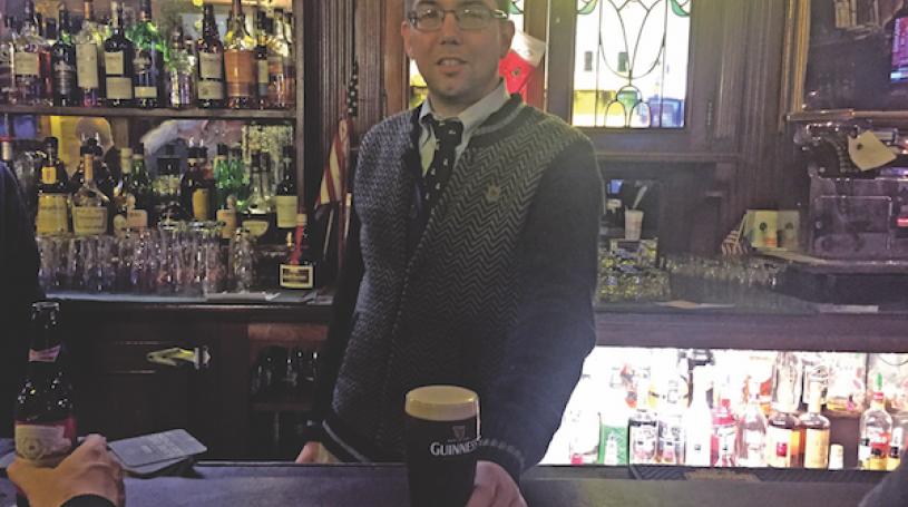 Fourth-generation Peter McManus Cafe owner Justin McManus serves up a well-poured Guinness. File photo by Dennis Lynch.